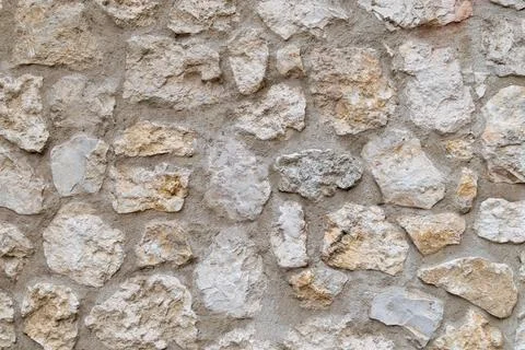 Rough stone wall texture with beige and white tones Stock Photos