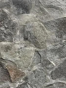 Rough stone wall with uneven, natural textures Stock Photos