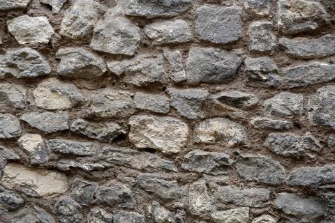 Rough stone wall for use as a background texture Stock Photos