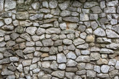 Rough stone wall for use as a background texture Stock Photos