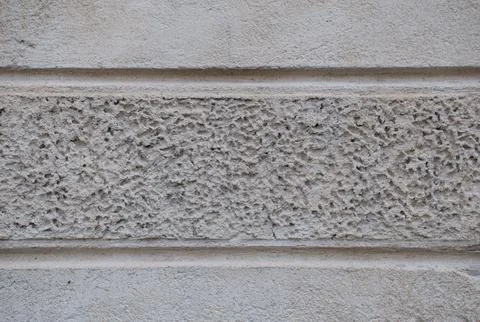 Rough stucco plaster wall texture with granular, weathered architectural surface Stock Photos