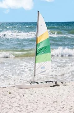 Rough surf with sailboat Stock Photos