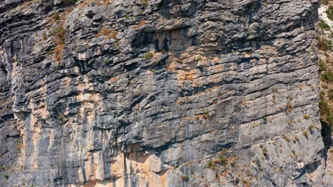 Rough surface and texture of rock on a vertical cliff. Geological layers Stock Footage 159767921