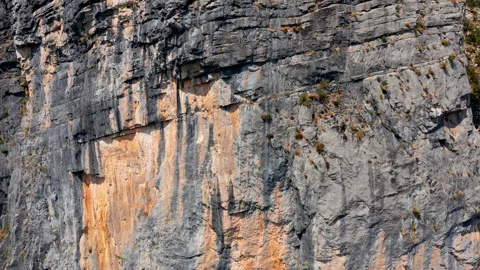 Rough surface and texture of rock on a vertical cliff. Geological layers Stock Footage 159769507