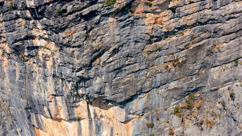 Rough surface and texture of rock on a vertical cliff. Geological layers Stock Footage 159770910