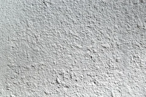 The rough surface of the concrete wall. Plaster is painted with gray paint. Stock-Fotos