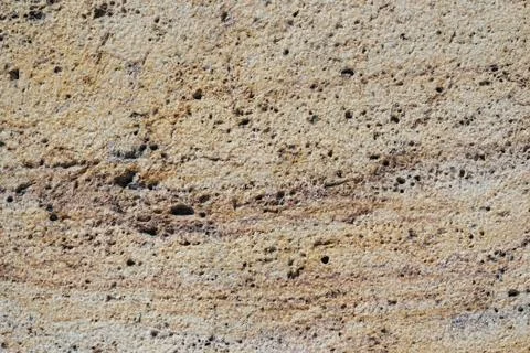 Rough surface of an eroded travertine marble stone Stock Photos