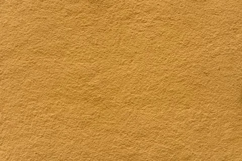 Rough surface of light brown color as background Stock Photos