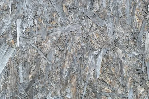Rough surface. Particle board or chipboard. Engineered wood. Abstract gray ba Stock Photos