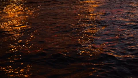 Rough surface of river reflecting the city lights at night Stock Footage 295102962