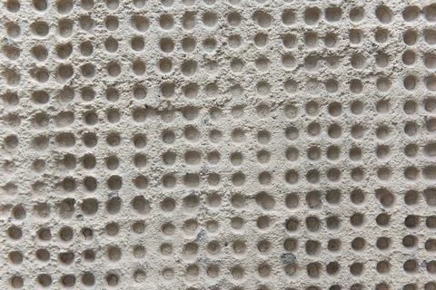 Rough surface texture of sand screed cement wall with holes Stock Photos