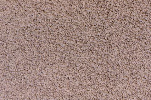 Rough tan stucco wall texture. Decorative cement plaster surface background Фото