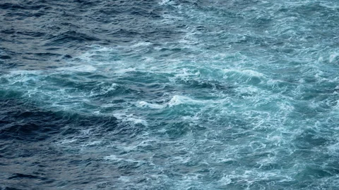 Rough teal wake water on the open sea from a ship 스톡 동영상 347826410