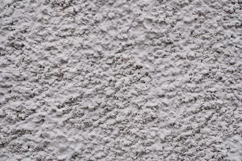 Rough texture of a fragment of an old wall painted with gray paint Stock Photos