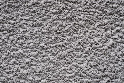 Rough texture of a fragment of an old wall painted with gray paint Stock Photos