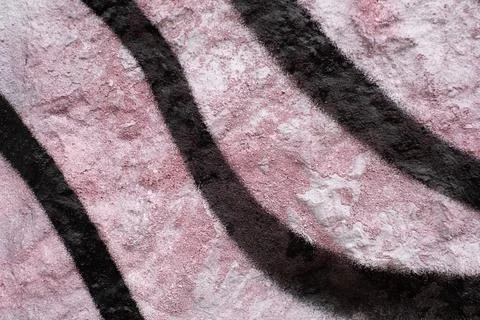 Rough texture of a fragment of an old wall painted with light red paint, black Stock Photos