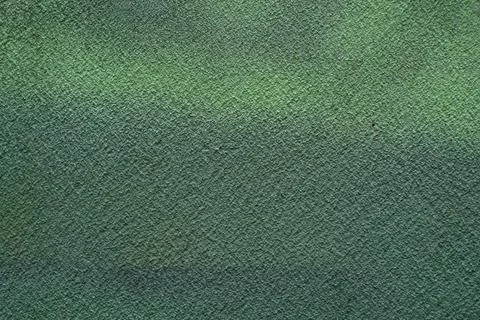 Rough texture of a fragment of an old wall painted with green paint Stock Photos