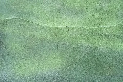Rough texture of a fragment of an old wall painted with green paint Stock Photos
