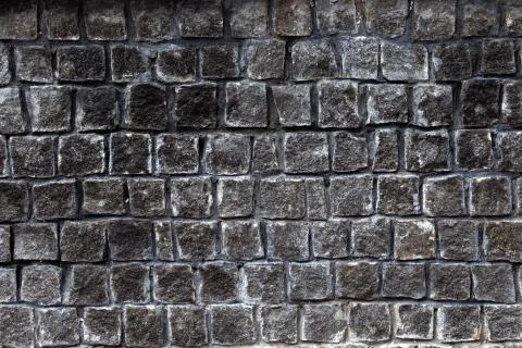 Rough texture of gray granite bricks wall Stock Photos