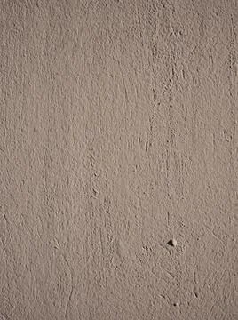 Rough texture of light brown stucco on the wall. Stock Photos