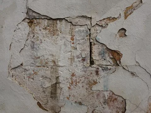 Rough texture of a stone wall with traces of cement and paint Stock Photos