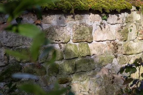 Rough texture of very old weathered stone wall or fence with traces of time a 스톡 사진