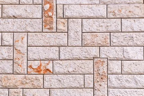 Rough textured light colored stone blocks creating an intricate pattern on .. Stock Photos
