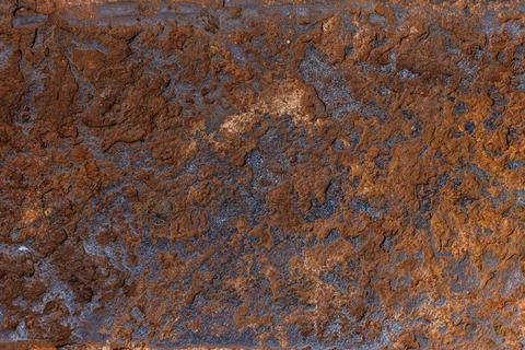 Rough textured rust surface in natural outdoor setting Фото