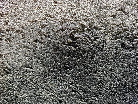 Rough textured surface of a dark concrete wall Фото
