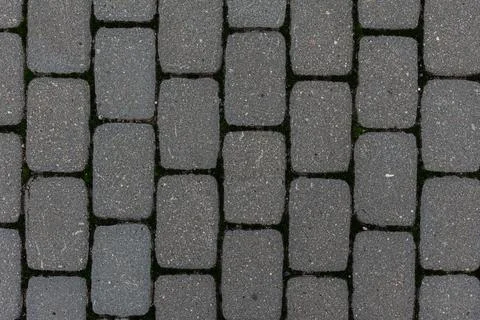 Rough textured surface of medium gray paving slabs in close-up. top view Stock Photos