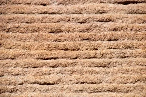 Rough textured surface of a sandstone wall Stock Photos