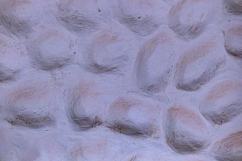 Rough textured wall presenting an abstract, organic pattern with uneven, ro.. 写真素材
