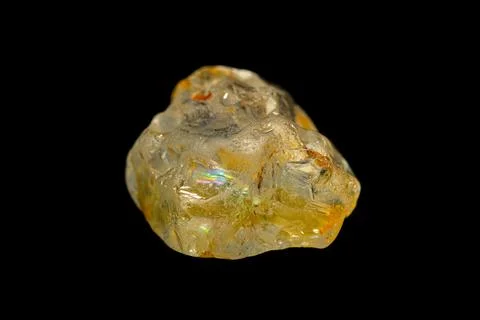 Rough Topaz gemstone on dark background Stock Photos