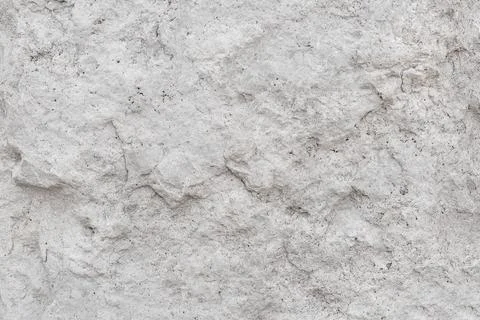 Rough, uneven texture stone of a gray concrete wall close up Foto stock