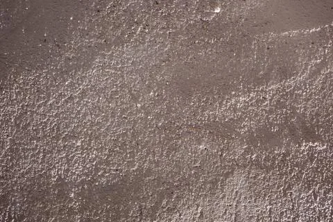 Rough uneven textured surface of plaster wall Stock Photos