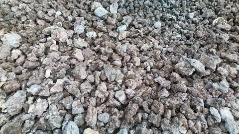 Rough volcanic rock texture background with porous lava stones Stock Photos