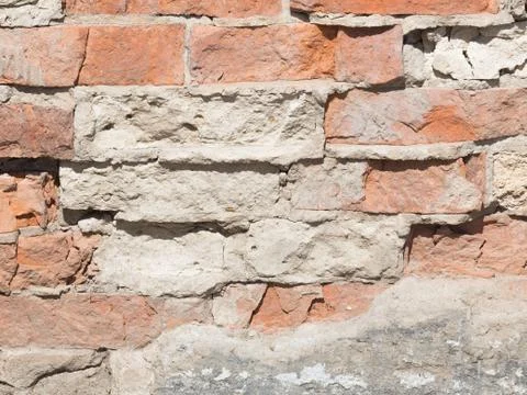 Rough wall with red bricks Stock Photos