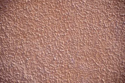 Rough wall stucco texture painted salmon. Stock Photos