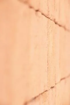 Rough wall surface of solid orange bricks with a point focus. Stock Photos
