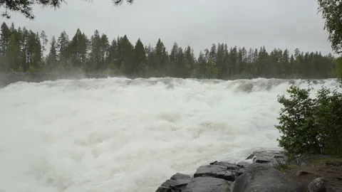Rough water flows over precipice of Storforsen Waterfall Stock Footage 147882211