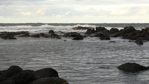 Rough waves break along the border of a tide-pool Stock Footage 98211134