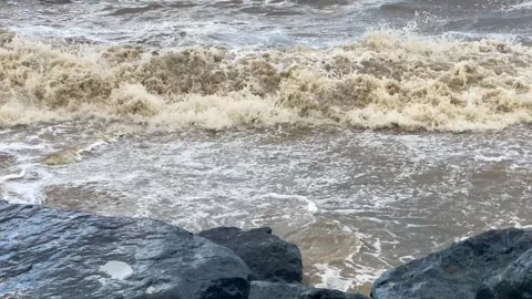 Rough waves breaking on rocks, close-up view of turbulent sea water Stock Footage 345361670