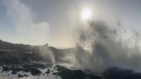 Rough Waves Breaking On Volcanic Rocks During Sunrise. Static Shot Stock Footage 255114349