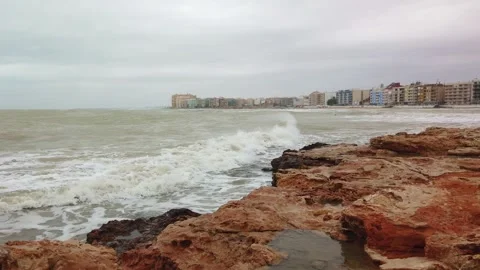 Rough Waves Crashing Against Rocky Cliffs Along Urban Coastal Shoreline Video stock 342126331