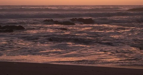 Rough waves at dusk on beach with vivid colors. Truck right parallel to shore Stock Footage 116584614