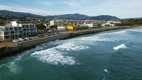 Rough waves hitting city shoreline with shops Stock Footage 88384366
