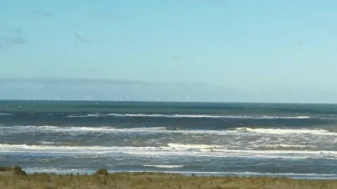 Rough waves of the North sea close to the beach with beach grass in foreground Stock Footage 196857769