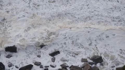 Rough waves of the ocean, filmed from the edge of a cliff crashing on the rocks Stock Footage 259827209