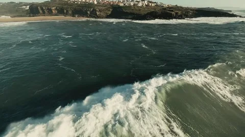 Rough waves roll toward a rocky shore Stock Footage 339792561