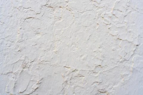 Rough white plaster wall texture with natural cracks 写真素材